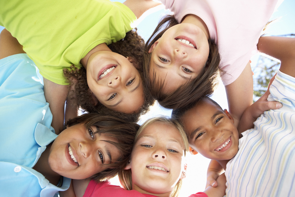 a group of young children standing in a circle