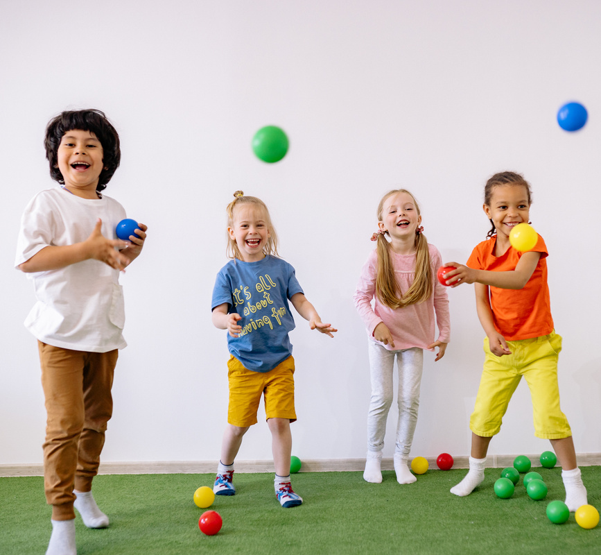 a group of children playing with balls in a room